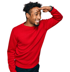Young african american man with beard wearing casual winter sweater very happy and smiling looking...