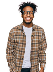 Young african american man with beard wearing casual clothes and glasses with a happy and cool...