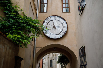 Fototapeta na wymiar Facade of an old building with windows and an old large clock. Ukraine, Lviv