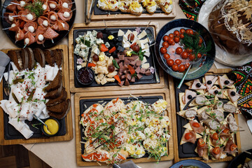 Buffet table with food and snacks for the guests of the event. Service at business meetings, weddings. Full table of appetizers