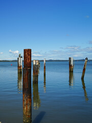 Rusted and weathered bollards in the sea at Redland Bay, Queensland, Australia 