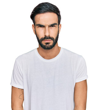Young hispanic man wearing casual white t shirt skeptic and nervous, frowning upset because of problem. negative person.