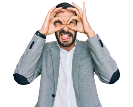 Young hispanic man wearing business clothes doing ok gesture like binoculars sticking tongue out, eyes looking through fingers. crazy expression.