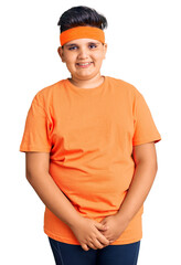 Little boy kid wearing sportswear winking looking at the camera with sexy expression, cheerful and happy face.