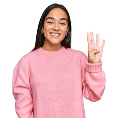 Young asian woman wearing casual winter sweater showing and pointing up with fingers number four while smiling confident and happy.