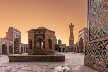 Courtyard of ancient Kalyan mosque with minaret in background in mystical light, Bukhara, Uzbekistan