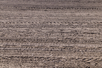 plowed soil in an agricultural field during tillage