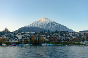 View of Spiez ,  Mountain Niesen , Spiez harbour . Beautiful city near  Lake Thun during autumn ,  winter morning  : Spiez , Switzerland : December 4 , 2019
