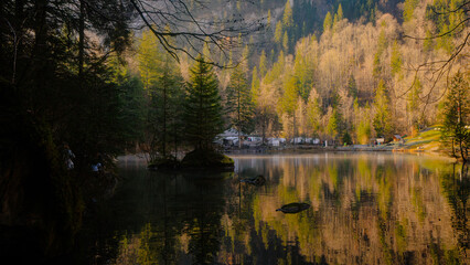 Fototapeta na wymiar Blausee , beautiful turquoise nature lake in Bernese Oberland, Kandergrund during autumn , winter morning : Blausee , Switzerland : December 4 , 2019