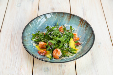 salad with shrimp, avocado, fresh vegetables and herbs