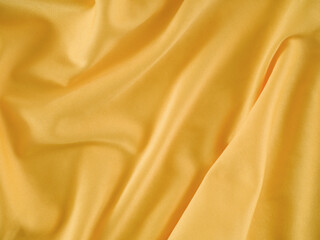 Fototapeta premium A crumpled gold fabric background