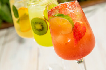 fresh lemonades from different fruits in a glass