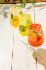 fresh lemonades from different fruits in a glass