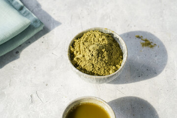 Step by step matcha latte: tall boba tea glass with ice, matcha green tea, milk