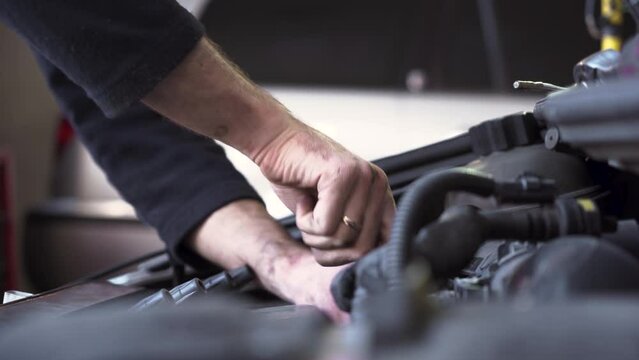 auto mechanic repairing the engine of an old car. close-up