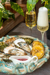 open and closed oyster with sauce and lemon