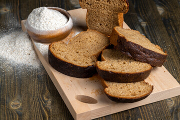sliced rye bread on a wooden table, close up