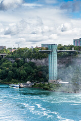 Niagara Falls, USA - Sept. 2022 view from Canadian side across the river to  the "Niagara Falls Observation Tower" on US side,  located next to the American Falls and the Bridal Veil Falls