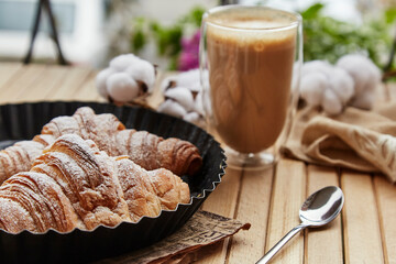 Aesthetic breakfast at the terrace - fresh french croissants, cup of latte outside. Autumn...
