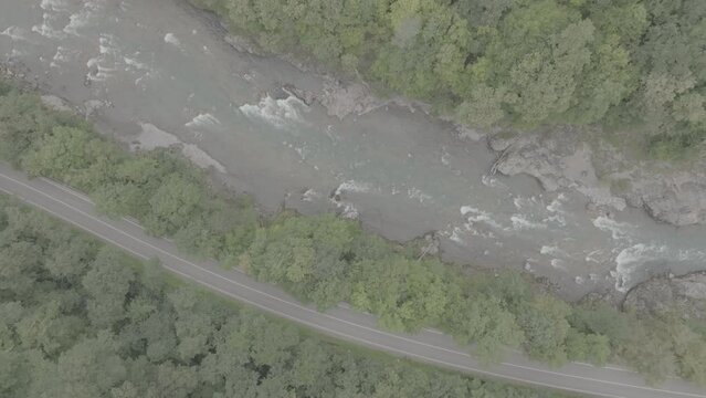 Aerial view of Mountain river and road. Flying over a mountain gorge. ProRes 422, 10 bit ungraded DJI D-LOG video