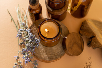 Soy candles in a glass jar. Aromatherapy. Burning candle and lavender. Wooden lid for jars. Beige...