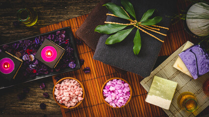 Fototapeta na wymiar Spa and Wellness Treatment Decorations accessories Inspirations with herbal, sponge scrub, aroma candles, plumeria frangipani flowers, and towels, for body and skin care therapy and relaxation