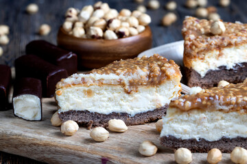 A piece of cheesecake cake with roasted peanuts in caramel