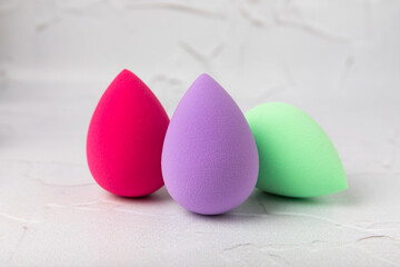 Beauty blender.Colorful beauty sponges on white marble background. Cosmetic tool for applying and blending products such as foundation and concealer. Copy space. place for text.