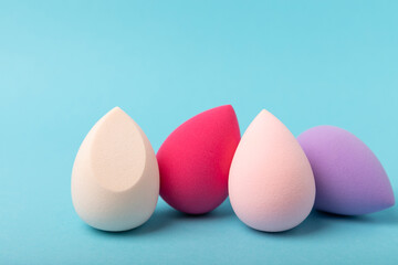 Beauty blender.Colorful beauty sponges on blue background. Cosmetic tool for applying and blending products such as foundation and concealer. Copy space. place for text.