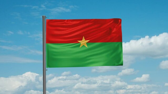 Burkina Faso flag with blue sky waving in the wind cycle looped video