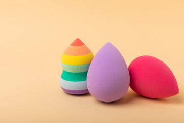 Beauty blender.Colorful beauty sponges on a beige background. Cosmetic tool for applying and blending products such as foundation and concealer. Copy space. place for text.