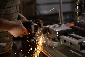 Metal treatment. Grinding of steel. Sparks from disk. Work in workshop.