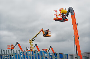 Access platform equipment powered high in sky at construction building site