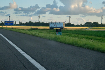 Fototapeta na wymiar Banner next to highway with text 'Now resist, stop idiotic nitrogen law' Dutch farmers protest against the plans of the government forced shrinking of livestock because of CO2 and nitrogen emissions.