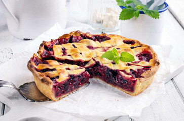Traditional French cherry pie with fresh fruits served as close-up on a cake plate
