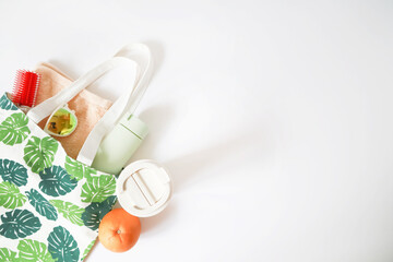 summer holiday concept , beach accessories , cotton bag , sun glasses , orange ,mug on white background , top view, tropical vacation travel concept	
