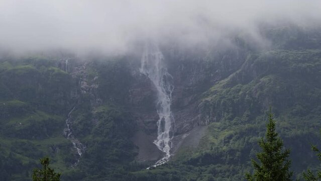 Alpine waterfall in the mountains on a cloudy misty day. Panasonic Lumix S1 ProRes422HQ (4K, 29.97fps, Vlog basic color correction)