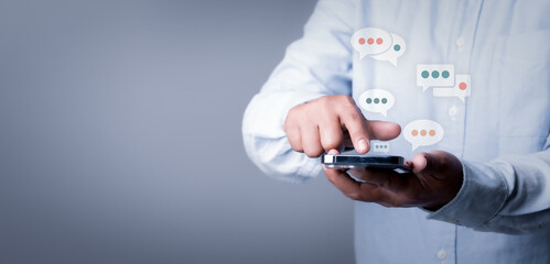 Women hand using smartphone typing Live chat chatting and social network concepts, chatting conversation working at home in chat box icons pop up. Social media marketing technology copy space concept.