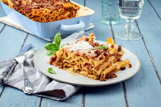 Traditional Italian candele alla marcinata pasta with miced meat and parmesan cheese served as close-up on a classic white plate