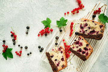 sliced pieces of homemade berry pie lie on a white wooden board with black and red currants 1