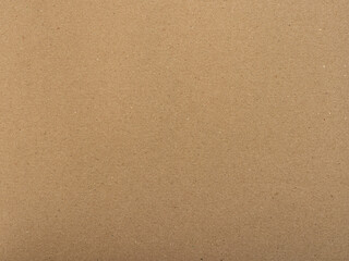 Fototapeta na wymiar Brown paper texture. Textured background as a blank copy space. Cardboard structure with fine fiber details. Packaging material for a wrapping purpose. The carton is made of recycled materials