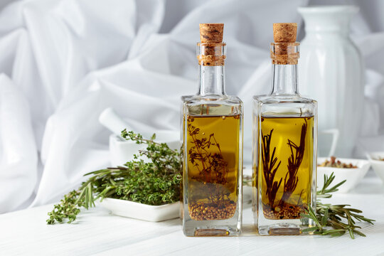 Bottles of olive oil with spices and herbs.