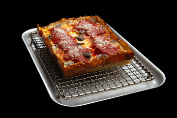 Detroit pizza with meat and sauce on an iron tray