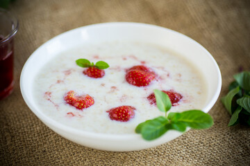 sweet milk oatmeal with strawberries in a plate
