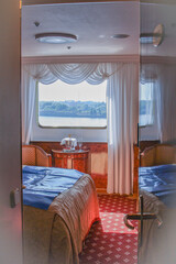 Luxurious ocean view or oceanview or outside or exterior porthole window cabin suite on luxury ocean liner cruiseship cruise ship in classic classy Belle Époque interior design	