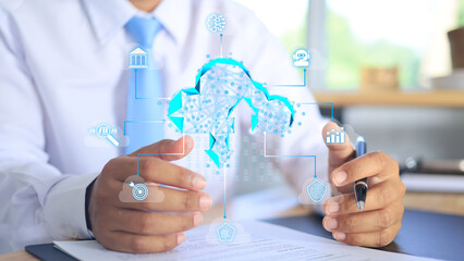 A businessman in a white shirt is using cloud data warehouse to download or upload the information needed to run their business such as audience, profit, finance, security, ai.