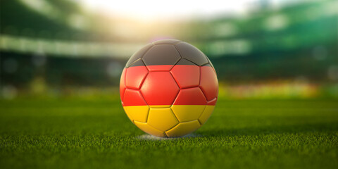 Football ball with flag of Germany on the field of football stadium and space for name of football clubs. Football championship of Germany concept.