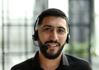 Portrait of an attractive businessman working in a call center