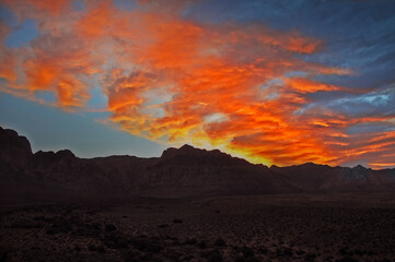 Red Orange Sunset Fire Clouds in Sky above Mountain Range 