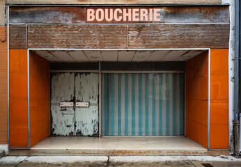 Facade of out of business Butcher shop in the south of France